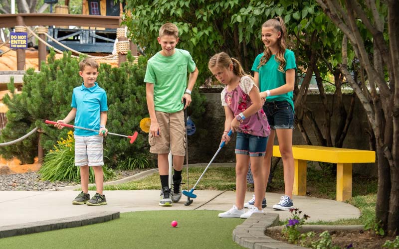 Young group playing mini golf